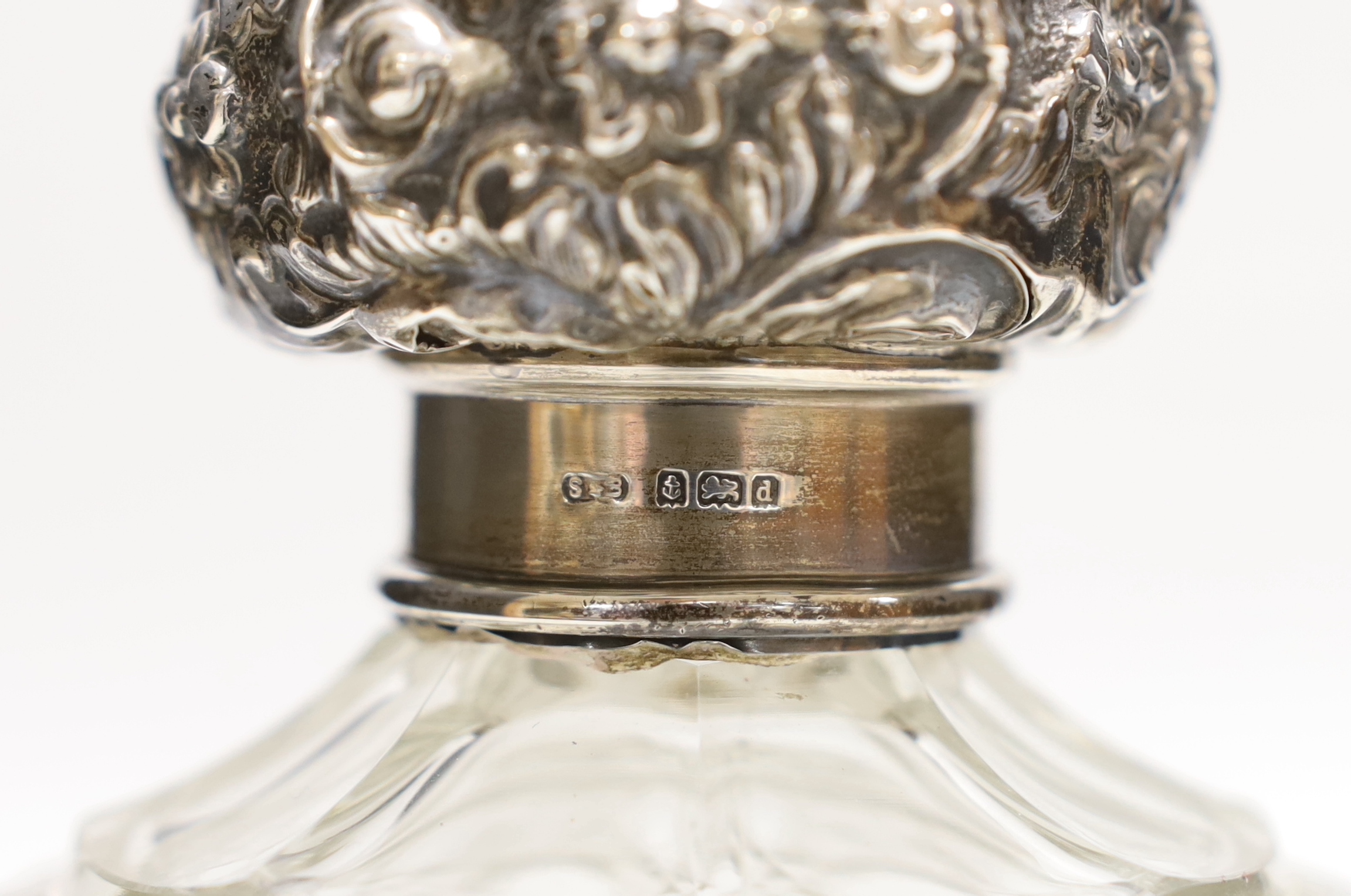 A George V silver mounted glass inkwell and three silver mounted cut glass scent bottles, largest 16cm (a.f.).